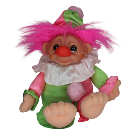 Plush toy gnome with pink hair and green outfit on a white background